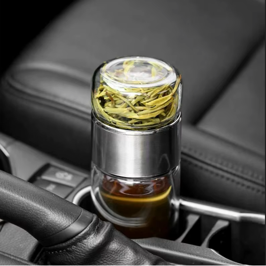 Glass tea infuser bottle in a car cup holder, ready for the journey