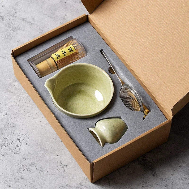 The open kraft gift box with the bowl, whisk holder, whisk, sieve and bamboo tools set in their places