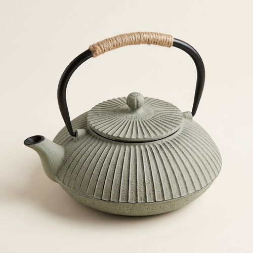Flat cast iron teapot in grey, with a ribbed body and cord-wrapped handle