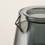 Close-up of the pouring lip and rim of the smoke grey glass teapot
