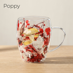 Poppy design: glass cup with dried red flowers and a lemon slice, on a light oak table