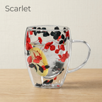 Scarlet design: glass cup with dried red and black petals and a lemon slice, on a light oak table